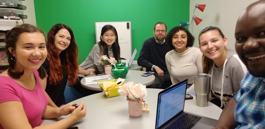 A diverse group collaborating around a table during a working session.